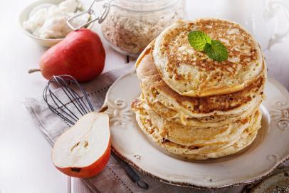 https://food.fnr.sndimg.com/content/dam/images/food/fullset/2023/12/6/stack-of-oat-flour-pancakes-on-white-plate-with-halved-pear-and-jar-of-oats-on-white-background.jpg.rend.hgtvcom.406.271.suffix/1701881977085.jpeg