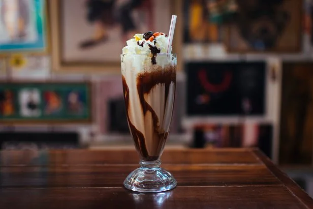 Decadent freakshake, topped with whipped cream, chocolate syrup and M&Ms.