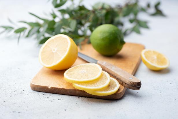 Citrus slices on wooden board. Cooking process