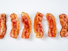 Fried bacon strips on the white background