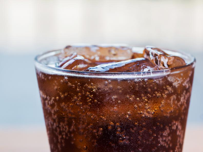 Close-up glass of cola with ice cubes.