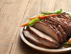 barbecue beef brisket with copy space isolated on brown wooden board