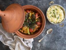 This classic Moroccan dish--a fragrant stew of vegetables and chicken, lamb or meatballs—is traditionally slow cooked in a clay vessel that gives the dish its name.