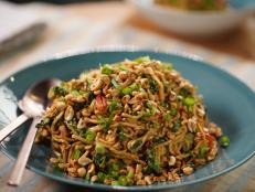 This dish has taste and texture coming from all directions. You can adjust some of the flavors to your liking. For example, omit the hot sauce and reduce the amount of fresh chile if you like it less spicy. You can also omit the peanuts to reduce the peanut flavor. This is inspired by a Chinese American noodle dish my father would make with tons of scallions and soy sauce. I love the thickness of the peanut sauce and the satisfying way the richness is balanced by the heat and all the fresh herbs. I usually serve it with roasted chicken or sides of roasted vegetables.