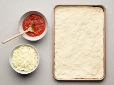 If you love the flavor and freshness of homemade pizza dough but are scared of kneading and proofing, we have the recipe for you! Pull out your bread machine. It takes all the guess work out of pizza dough—just add the ingredients and walk away. Out comes enough beautiful dough for a sheet pan pizza or a deep-dish skillet pizza.