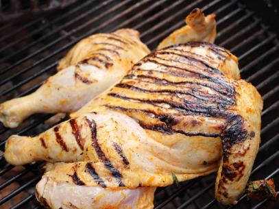 Spatchcock Chicken on the grill, as seen on Symon's Dinners Cooking Out, Season 4.