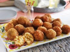 You know your girl loves mac 'n' cheese, so I decided to whip my mac 'n' cheese recipe into something a little more festive: mac 'n' cheese balls. They may seem tricky to make, but believe me, they're easy. All you do is chill the mac 'n' cheese, scoop it into balls, roll it in some panko breadcrumbs, and then fry them up. They're so ooey gooey and delicious.