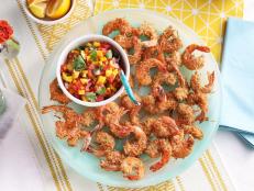 In this festive recipe, the crispy shrimp gets its crunch from panko breadcrumbs and sweetness from sweetened coconut flakes. It's the perfect vehicle for a rainbow-colored fruit salsa bursting with tropical flavors. The salsa is so delicious, you may want to keep some on hand for chip-dipping.
