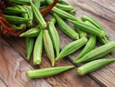 Lady Fingers or Okra over wooden table background