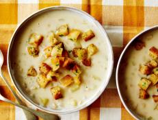 For a bowl of creamy comfort, try Dave Lieberman's New England Clam Chowder recipe from Food Network, perfect with homemade baguette croutons.