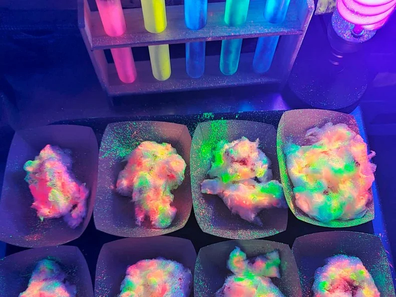 Over-the-Top treat from COLORADO. Glow-in-the-Dark Cotton Candy - Edible bioluminescent powder lights up this goodie at Denver’s Inventing Room Dessert Shop.
