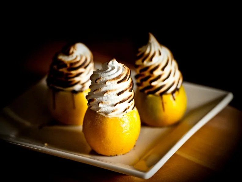 Over-the-Top treat from MONTANA. The Flaming Orange. Hollowed oranges are lined with dark chocolate\, filled with ice cream and meringue and set aflame tableside at Chico Hot Springs Resort in Pray. Chico Hot Springs