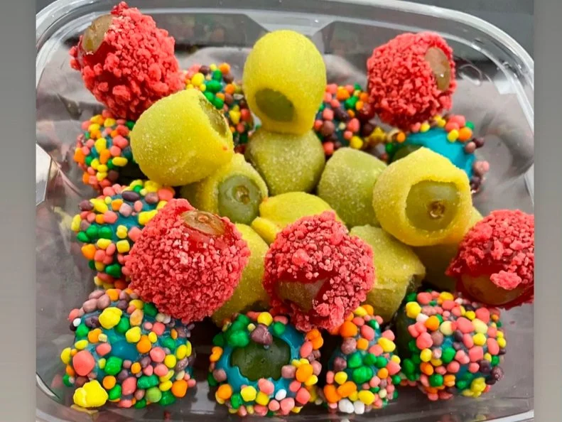 Over-the-Top treat from NORTH CAROLINA. Candy Grapes at Kandy Apples by K in Raleigh. Grapes are dipped in homemade liquid candy\, then coated with toppings like Nerds and Jolly Ranchers.