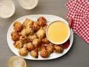 Food Network Kitchen’s Biscuit Pretzel Bites with Hot Dogs and Nacho Cheese Dipping Sauce as seen on Food Network.
