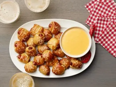Food Network Kitchen’s Biscuit Pretzel Bites with Hot Dogs and Nacho Cheese Dipping Sauce as seen on Food Network.