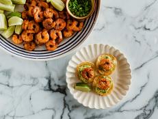 Tostadas are flat tortillas, fried or toasted until crisp, then adorned with various toppings. Ree has opted for a shortcut version, using round tortilla chips topped with Tex-Mex spiced shrimp, guacamole flavored with lime and cilantro, and refreshing pineapple.