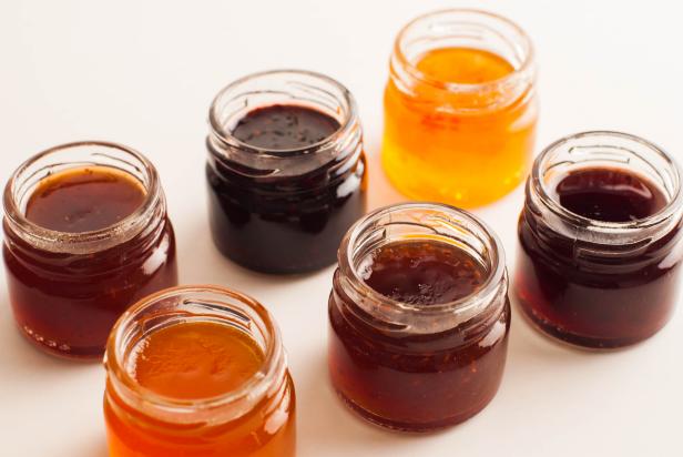 Financial concepts background variety of preserved fruit jams on a white background
