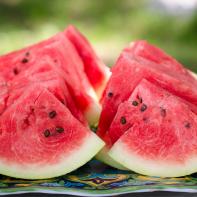 Dallas, TX - June 12, 2015: Freshly cut watermelon slices are displayed on a picnic table outside. The perfect food for a summertime picnic. They are ready to be eaten.
