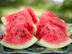 Dallas, TX - June 12, 2015: Freshly cut watermelon slices are displayed on a picnic table outside. The perfect food for a summertime picnic. They are ready to be eaten.