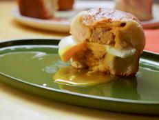 This recipe is Molly&rsquo;s breakfast version of the meatball-stuffed biscuits her mom made for dinner growing up. Her mom would use frozen meatballs, store-bought biscuits and store-bought red sauce&hellip;so this is her slightly fresher take with homemade sausage. She encapsulates the meatball like a dumpling, adds in some sliced cheese, bakes it, cooks up an egg and serves it all together with maple syrup for dunking &mdash; yum!