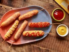 When Molly first experienced Korean corn dogs, she was floored and thought they were incredible. The skewered combination of a fried hot dog and string cheese felt like a mozzarella stick and a corn dog made a delicious baby. This is her take on recreating that recipe: deep-fried and crispy all-beef hot dogs and cheese, dusted in sugar to finish, with ketchup and mustard for dipping. They&rsquo;re sure to send anyone to corn dog heaven.
