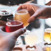 Friends toasting with beer at a bar during happy hour.  Cheers!