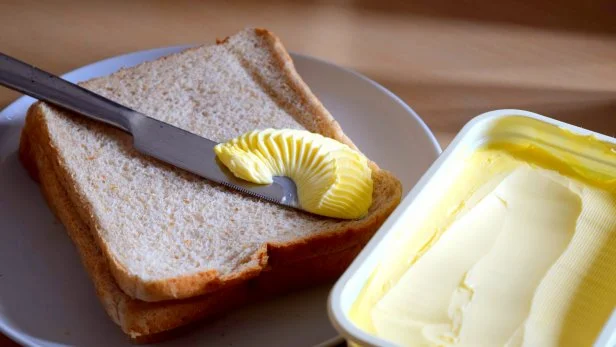 spreading margarine butter onto bread
