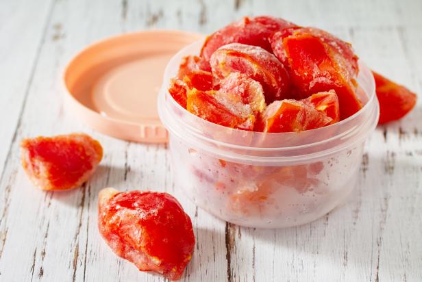 Healthy food is frozen food for the winter. Containers with frozen tomatoes.