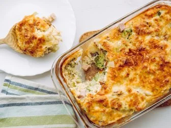 Top view of cauliflower, broccoli and cheese casserole in rectangular shape glass baking dish.