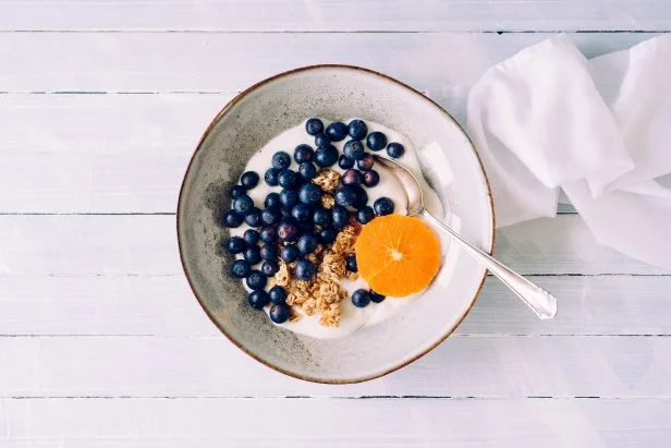 Granola with blueberries, tangerine and curd cheese