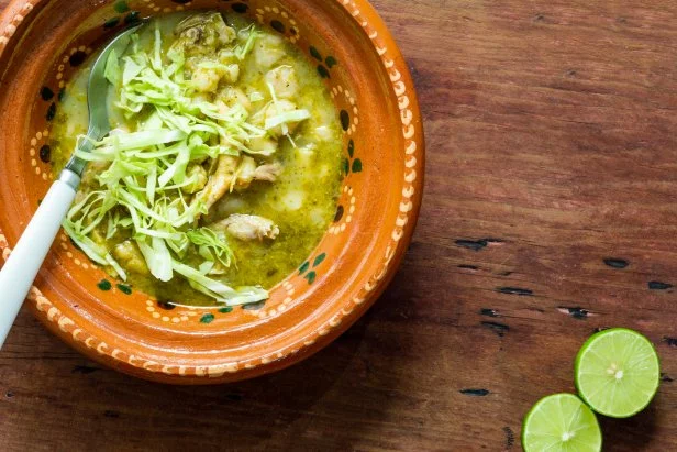 Pozole verde, or green posole is traditionally made with hominy and meat and topped with condiments. Mexican cuisine.