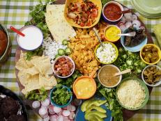 Everyone's all aboard the styled food board craze these days, including yours truly. But mine goes beyond charcuterie. I&rsquo;m debuting a BURGER board, because it&rsquo;s not summer without one. And a tasty Tex-Mex spin takes it to the next level. Grill up seasoned patties, then fill in your board with tons of toppings; the options are endless. Spicy jalape&ntilde;os, crisp radishes, nacho cheese and crunchy tortilla chips are a few of my faves. Put your board on a lazy Susan and guests will have a blast building their own burgers.