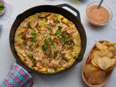 Eggs are what Molly reaches for when her kids are around to make quick and easy meals&hellip;and potato chips are what Molly reaches for when her kids aren&rsquo;t watching as her go-to snack: they&rsquo;re her kryptonite. This is her combination of the two into a creamy fluffy frittata loaded with gooey goat cheese and topped with a harissa drizzle; it&rsquo;s good and indulgent at the same time.