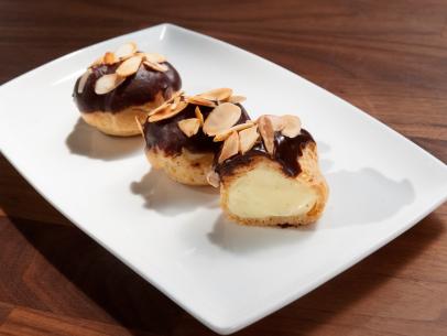 Anne Burrell’s Profiteroles with Almond Pastry Cream and Chocolate Ganache are displayed, as seen on Worst Cooks in America, Season 26.