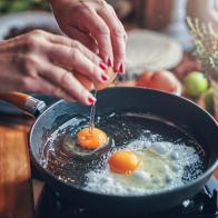 Frying Egg in a Cooking Pan in Domestic Kitchen