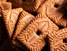 A portrait of a stackof brown cookies called speculoos or speculaas in Belgium or the Netherlangs. The spiced biscuit is very delicious and popular during the winter period to be eaten at any time.