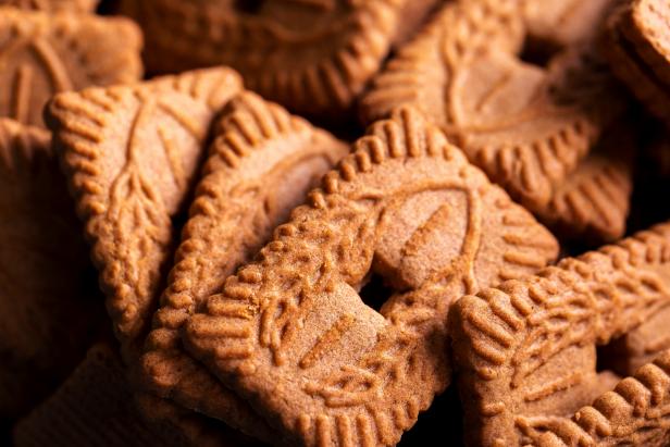 A portrait of a stackof brown cookies called speculoos or speculaas in Belgium or the Netherlangs. The spiced biscuit is very delicious and popular during the winter period to be eaten at any time.