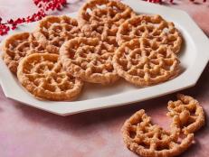 There are two types of buñuelos in Mexico: one is thin, crispy and covered in piloncillo syrup, and the other is crispy, shaped like a rosette or star and tossed in cinnamon sugar. This recipe is for the latter. Buñuelos de viento, or wind fritters, are traditionally eaten during the Christmas season and made in large quantities for posadas or Christmas parties. A little orange zest and optional orange liqueur in the batter add a touch of citrus.