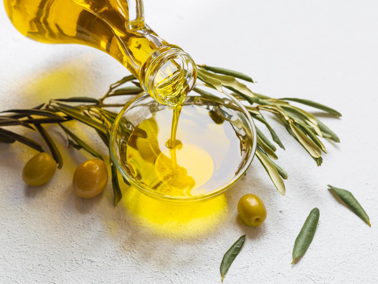 https://food.fnr.sndimg.com/content/dam/images/food/fullset/2023/9/19/olive-oil-pouring-into-bowl-with-olives-on-side-on-white-background.jpg.rend.hgtvcom.1280.960.suffix/1695126309040.jpeg