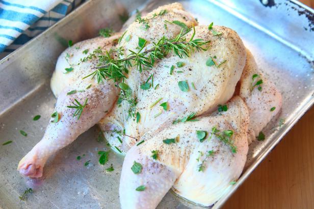 Raw chicken with seasoning and herbs ready to roast