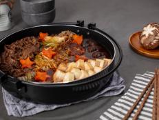 There are several types of sukiyaki in Asia, but what they all have in common is being cooked in a pot with broth, which gave them the name hot pot. This is Japanese Kanto-style sukiyaki, which is thin sliced super fatty beef along with vegetables cooked together into a broth.