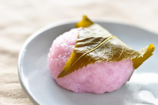 close-up of Japanese sweets Sakuramochi which is rice cake with bean paste wrapped in a preserved cherry leaf. These are often eaten at spring season and girls ' festival in March.