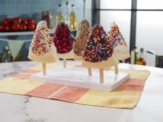 My mom started making a lightened-up cheesecake in the blender years ago, and I&rsquo;ve put my own spin on it with several different variations. Inspired by a frozen Key lime pie on a stick that I had in Key West, I decided to try her cheesecake recipe as a frozen handheld delight. The chocolate toasted quinoa topping is next level, same for the freeze-dried strawberries or raspberries, and chopped nuts or sprinkles never disappoint!