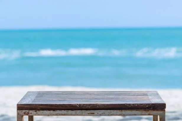 Top of the wood table in front of the white beach background. can be used for display or montage your products.