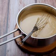 Light sauce in a style pot with whisk