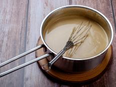 Light sauce in a style pot with whisk
