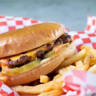 A closeup view of a cheeseburger.
