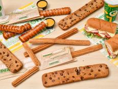 We got an advance taste of the sandwich chain’s new ruler-length chocolate chip cookie, Cinnabon churro and Auntie Anne’s pretzel, which arrive this month at locations nationwide.