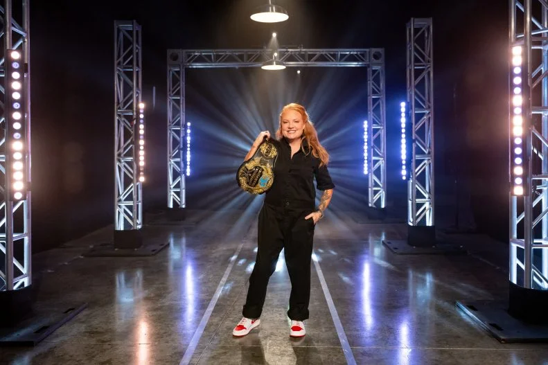 Contestant Tiffani Faison with her 2022 Tournament of Champions Belt, as seen on Tournament of Champions, Season 5.