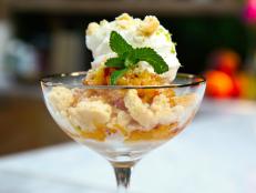This is a truly simple dessert and an easy hack for using up overripe peaches. Every time I indulge in this it takes me back to the heart of summer. Overripe peaches, frozen and grated, become a refreshing granita-like treat bursting with natural sweetness. The richness of the whipped cream with honey and vanilla and the crumbled shortbread cookies are a celebration of flavors and textures.
